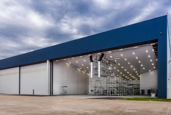 Exterior of MAAS Aviation Painting Facility. Hangar door open showing inside of painting facility.