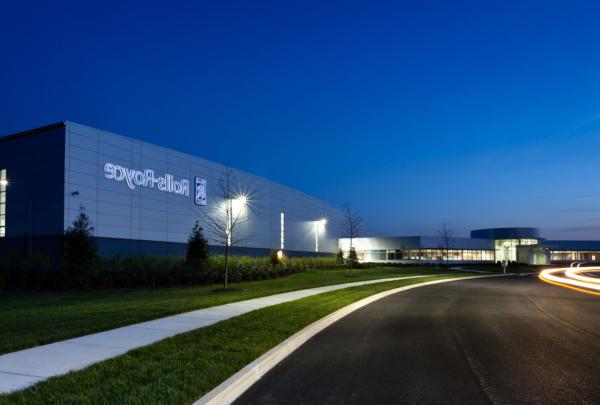 Exterior of Rolls Royce Crosspointe Rotatives Facility in the evening with street lamps on.